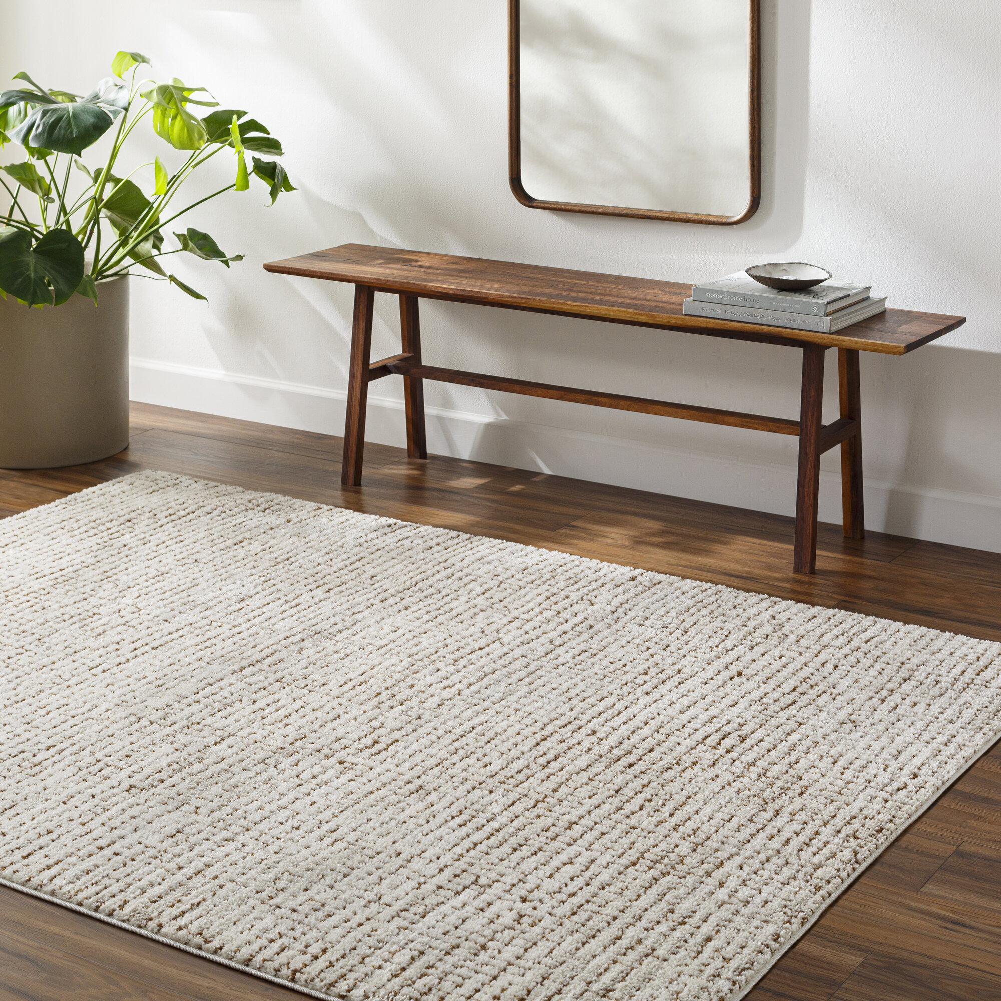 The Adler rug in Grid Walnut, laid out in the room