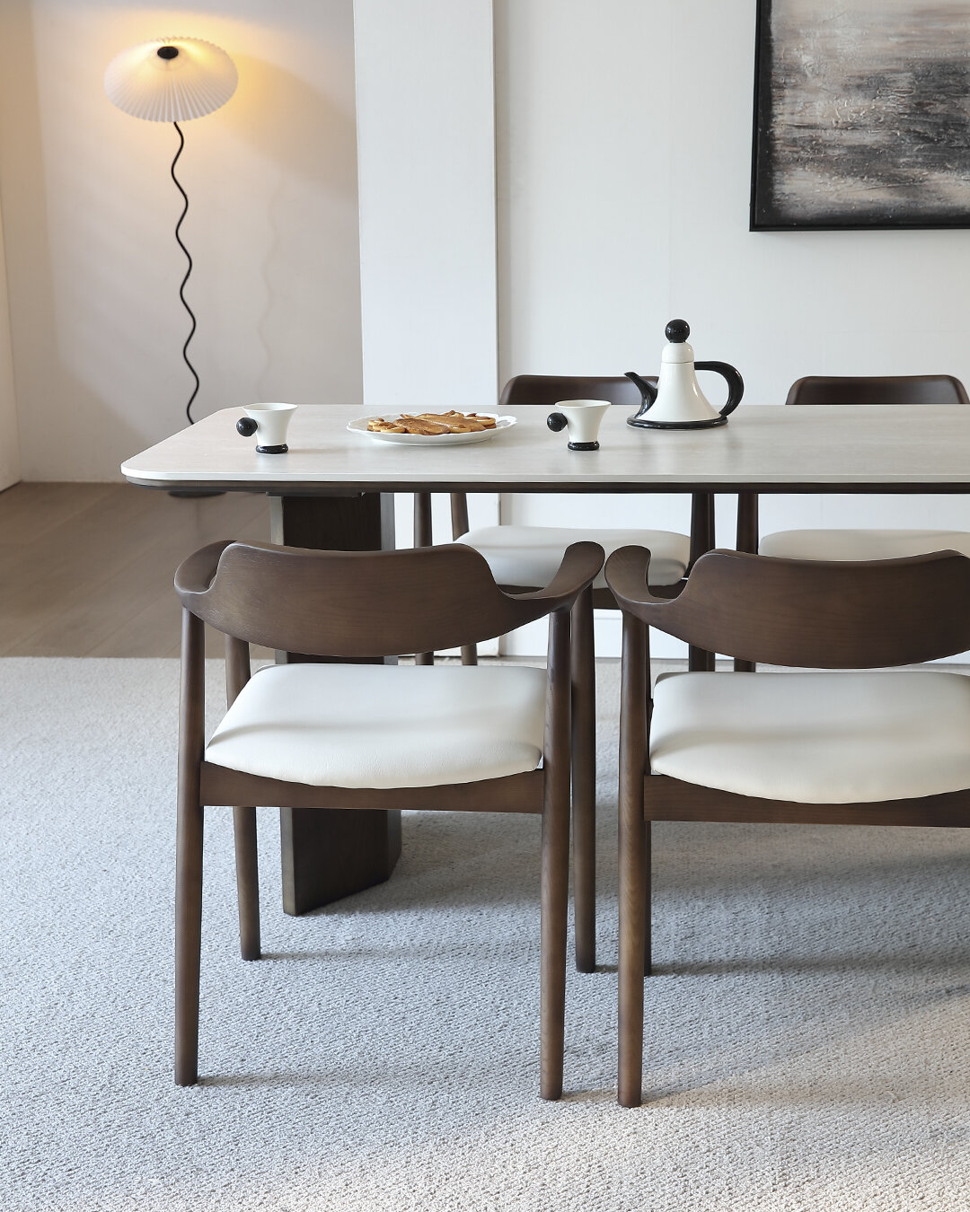 The Arano set around the dining table, showing the backrest flowing into the arms