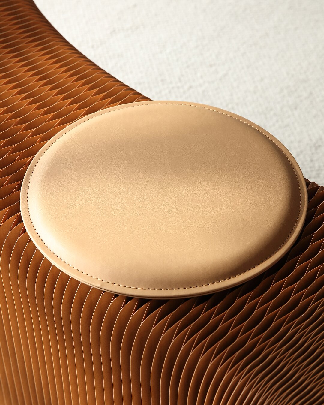 A round seat pad resting on the honeycomb kraft paper