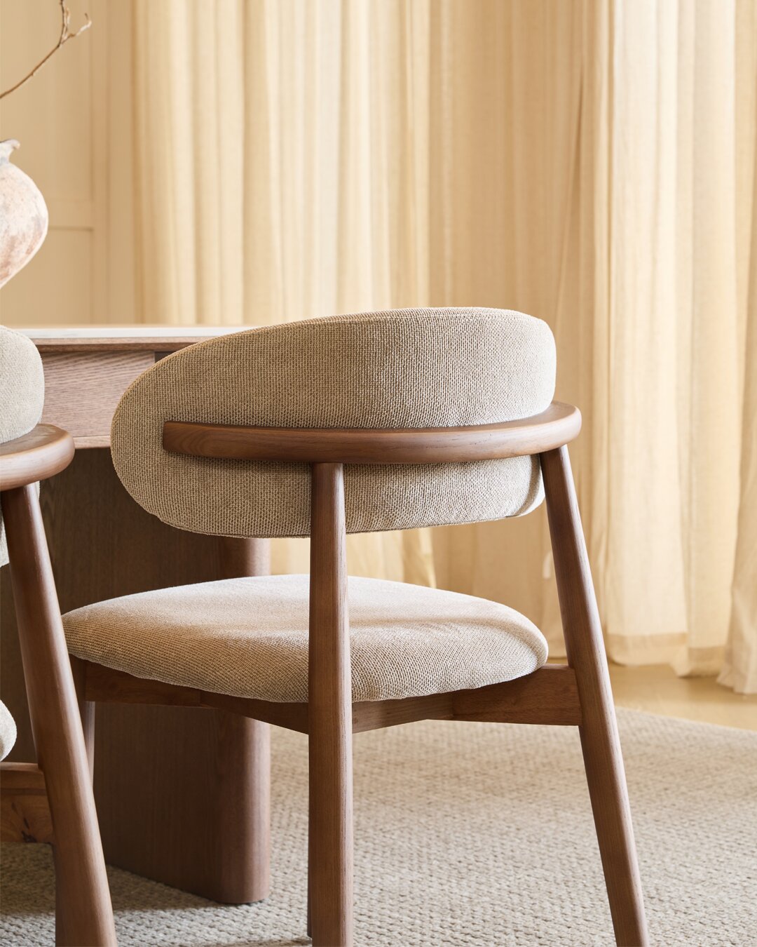 The curved rail that carries the backrest