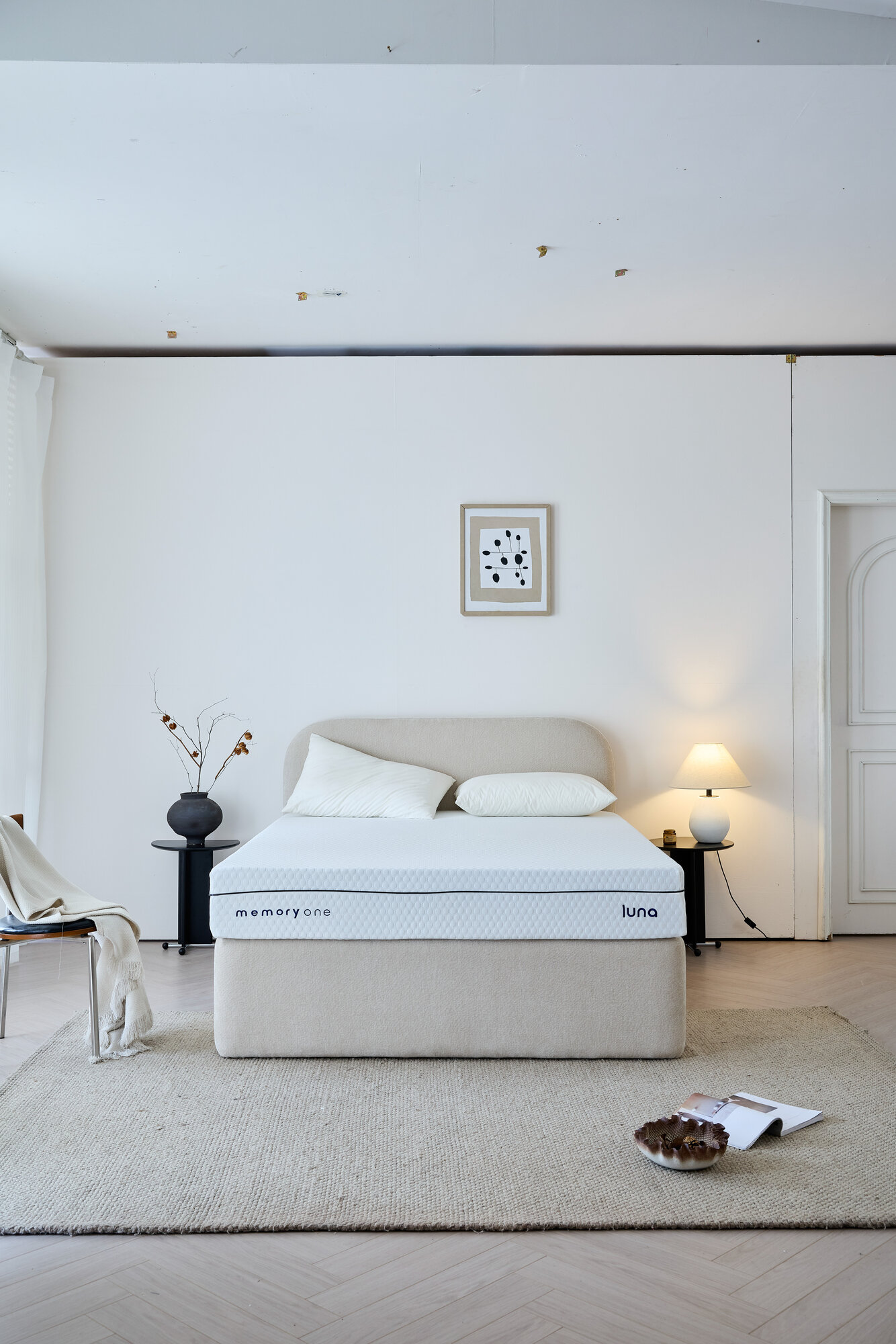 The Luna Memoryone mattress, made up for the night in a pale bedroom