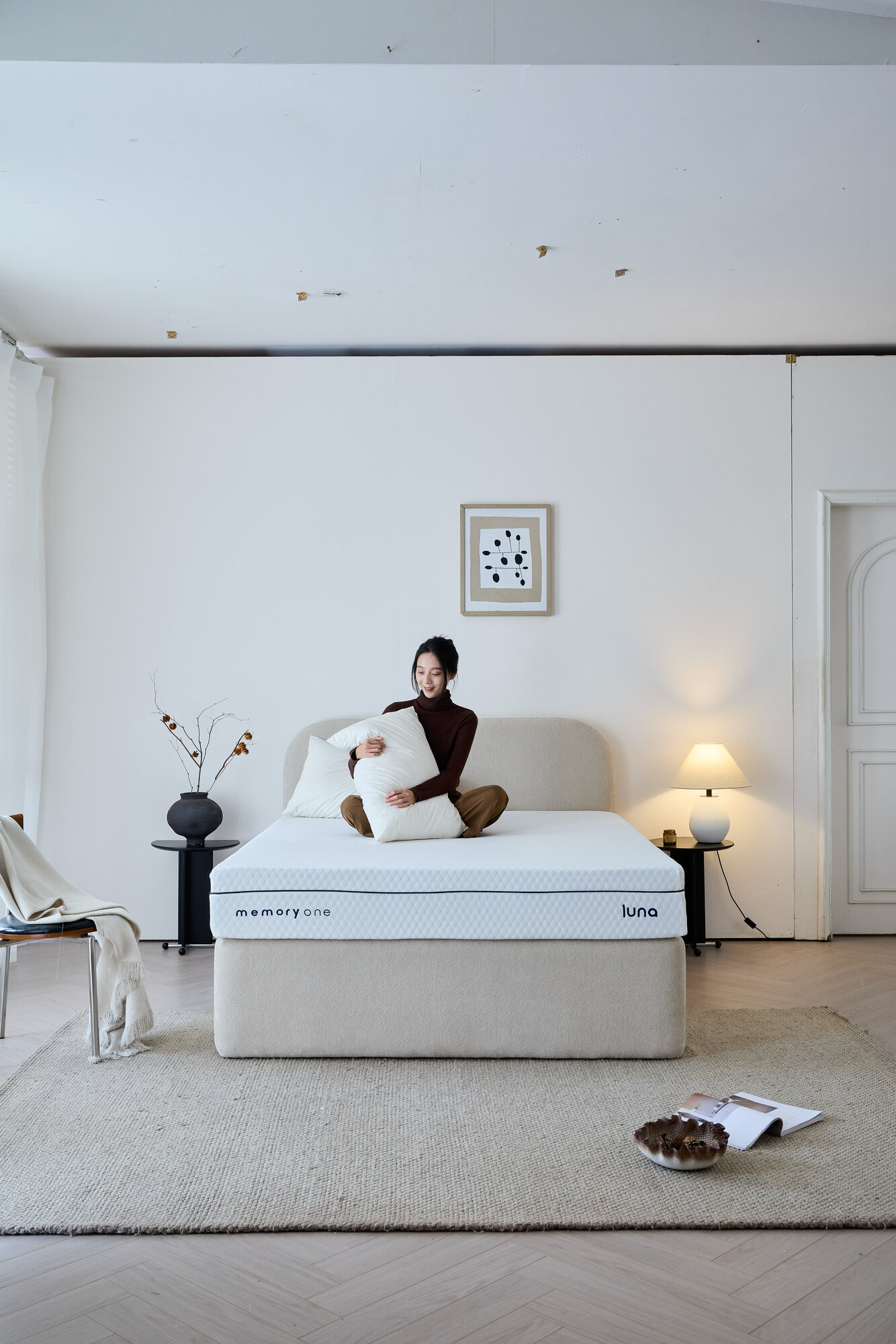 A woman sitting in the middle of the Luna, holding a pillow