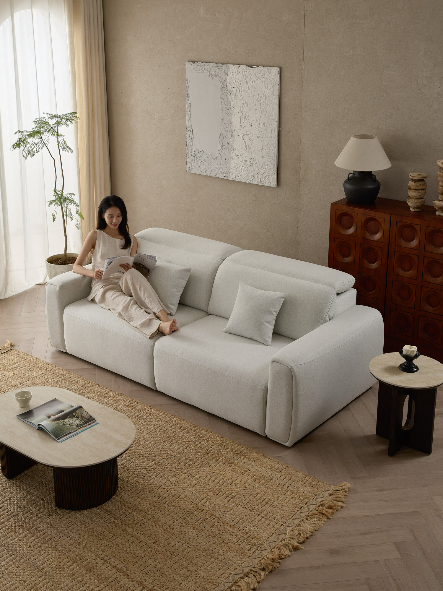 Anderson sofa in off-white bouclé, studio light across generous track arms